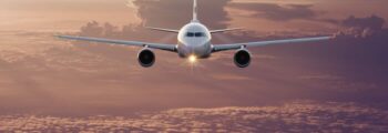 BBJ en vol avec couché de soleil au dessus de la mer et des côtes